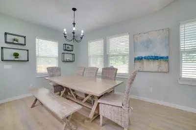 a dining room with a wooden table and chairs at West End Home with Yard Less Than 1 Mi to Beach Access! in Panama City Beach