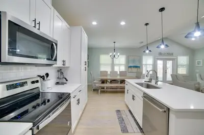 a kitchen with a sink and a stove top oven at West End Home with Yard Less Than 1 Mi to Beach Access! in Panama City Beach