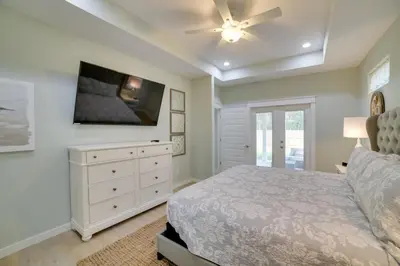 a bedroom with a bed and a ceiling fan at West End Home with Yard Less Than 1 Mi to Beach Access! in Panama City Beach