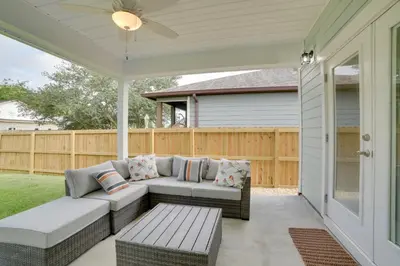 a patio with a couch and a table at West End Home with Yard Less Than 1 Mi to Beach Access! in Panama City Beach
