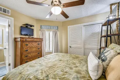 a bedroom with a bed and a tv and a dresser at Sea Hag by Book That Condo in Panama City Beach