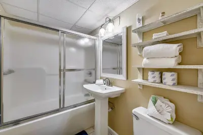 a bathroom with a shower toilet and a sink at Sea Hag by Book That Condo in Panama City Beach