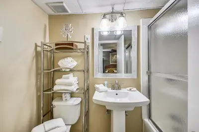 a bathroom with a sink and a toilet and a shower at Sea Hag by Book That Condo in Panama City Beach