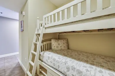a bedroom with two bunk beds and a staircase at Sterling Breeze #1702 by Book That Condo in Panama City Beach