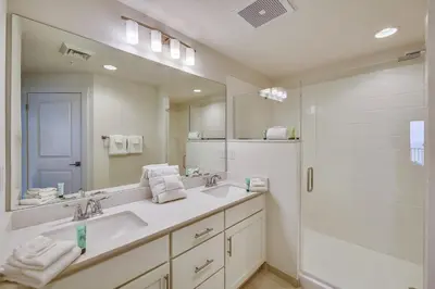 a white bathroom with a sink and a shower at Calypso Resort and Towers #1101-3 by Book That Condo in Panama City Beach