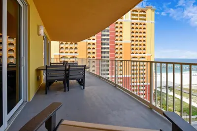 a balcony with a bench and a table on it at Calypso Resort and Towers #1101-3 by Book That Condo in Panama City Beach