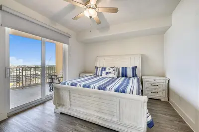 a bedroom with a bed and a ceiling fan at Calypso Resort and Towers #1101-3 by Book That Condo in Panama City Beach