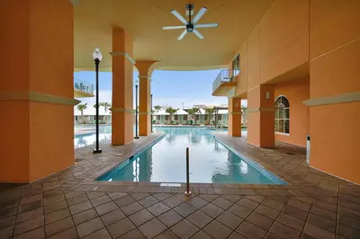 a swimming pool in a building with a ceiling at Calypso Resort and Towers #1101-3 by Book That Condo in Panama City Beach