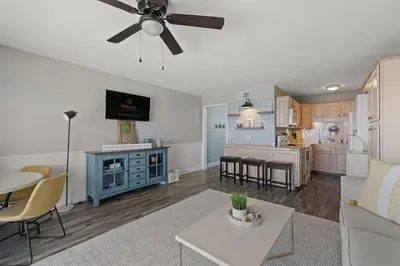 a living room and kitchen with a ceiling fan at The Summit 919 in Panama City Beach