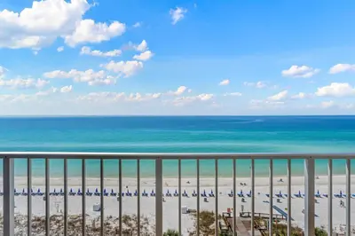 a view of a beach with chairs and the ocean at The Summit 919 in Panama City Beach
