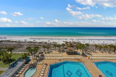 a view of the beach from the balcony of a resort at The Summit 820 in Panama City Beach