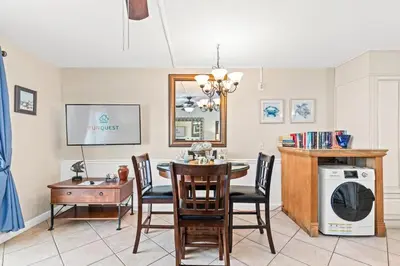 a dining room with a table and chairs and a microwave at The Summit 820 in Panama City Beach