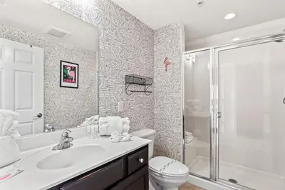 a bathroom with a toilet and a sink and a shower at Seychelles 1006 in Panama City Beach