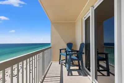 a balcony with two chairs and the ocean at Seychelles 1006 in Panama City Beach