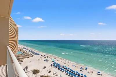 a view of a beach with umbrellas and the ocean at Seychelles 1006 in Panama City Beach