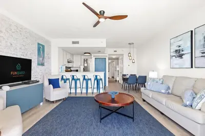 a living room with a couch and a table at Seychelles 1006 in Panama City Beach