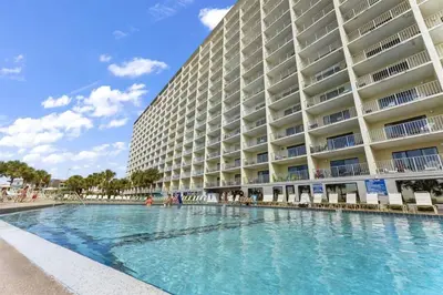 a large building with a swimming pool in front of it at The Summit 613 in Panama City Beach
