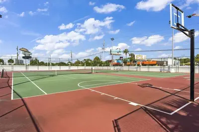 a tennis court with a net on a tennis court at The Summit 613 in Panama City Beach