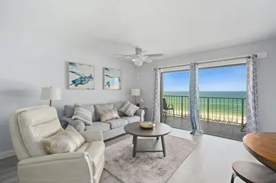 a living room with a couch and a table at The Summit 626 in Panama City Beach
