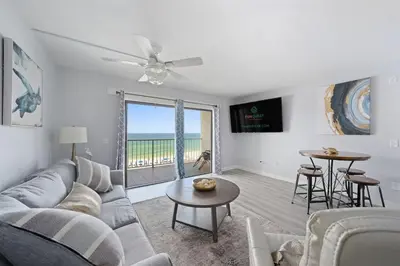 a living room with a couch and a table at The Summit 626 in Panama City Beach