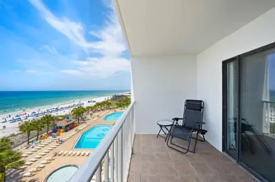 a balcony with a view of the beach and the ocean at The Summit 626 in Panama City Beach