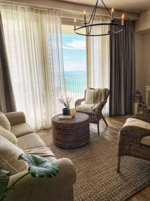 a living room with a couch and chairs and a chandelier at Shores of Panama Unit 1209 in Panama City Beach