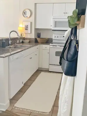 a kitchen with white cabinets and a black purse on the refrigerator at Shores of Panama Unit 1209 in Panama City Beach