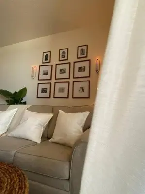 a couch in a living room with pictures on the wall at Shores of Panama Unit 1209 in Panama City Beach