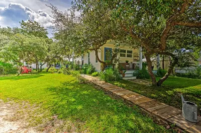 a house with a yard with grass and trees at Seagrove Beach Studio - quarter Mi to Beach Access! in Santa Rosa Beach