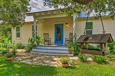 a house with a blue door and a yard at Seagrove Beach Studio - quarter Mi to Beach Access! in Santa Rosa Beach