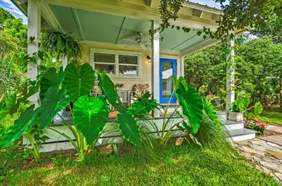 a front porch of a house with large green plants at Seagrove Beach Studio - quarter Mi to Beach Access! in Santa Rosa Beach