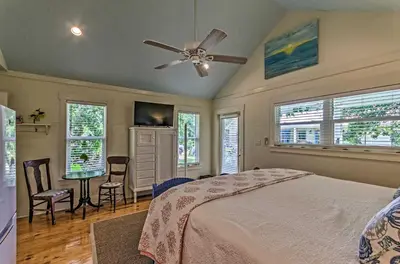 a bedroom with a bed and a ceiling fan at Tropical Studio quarter Mi to Public Beach Access! in Santa Rosa Beach