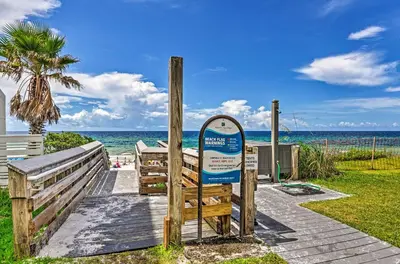 a sign on a wooden walkway to the beach at Tropical Studio quarter Mi to Public Beach Access! in Santa Rosa Beach