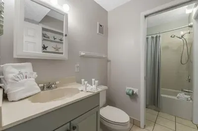a bathroom with a sink and a toilet and a shower at The Summit 1216 in Panama City Beach