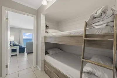two bunk beds in a room with a mirror at The Summit 1216 in Panama City Beach