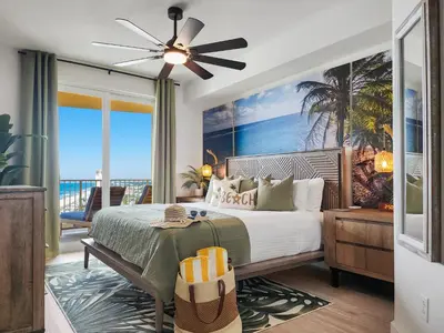 a bedroom with a bed with a view of the beach at Calypso Resort and Towers #1806-3 by Book That Condo in Panama City Beach