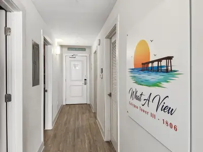 a hallway with a wall mural of a pier at Calypso Resort and Towers #1806-3 by Book That Condo in Panama City Beach