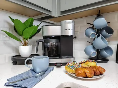 a kitchen counter with a plate of donuts and a coffee maker at Calypso Resort and Towers #1806-3 by Book That Condo in Panama City Beach