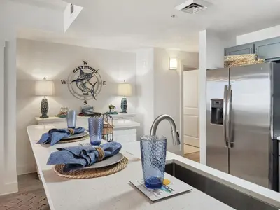 a kitchen with a sink and a refrigerator at Calypso Resort and Towers #1806-3 by Book That Condo in Panama City Beach