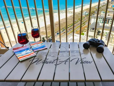 a table with two wine glasses and a view of the beach at Calypso Resort and Towers #1806-3 by Book That Condo in Panama City Beach