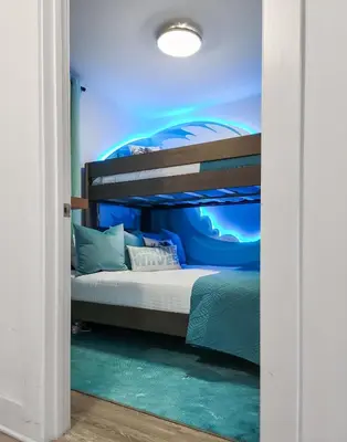 a bedroom with a bunk bed in a blue room at Calypso Resort and Towers #1806-3 by Book That Condo in Panama City Beach