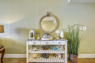 a white console table with a mirror and a sink at Majestic Beach Resort #1303-2 by Book That Condo in Panama City Beach