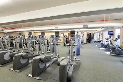 a gym with many rows of cardio machines at Majestic Beach Resort #1303-2 by Book That Condo in Panama City Beach