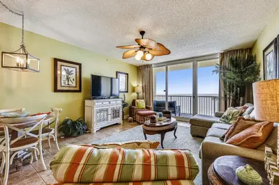 a living room with a couch and a tv at Majestic Beach Resort #1303-2 by Book That Condo in Panama City Beach