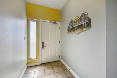 a hallway with a white door and a window at Shores of Panama #1725 at Book That Condo in Panama City Beach