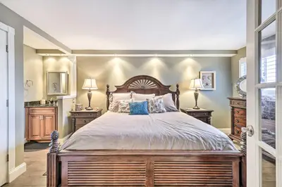 a bedroom with a large bed and two lamps at PCB Condo with 2 Outdoor Pools and Beach Access! in Panama City Beach