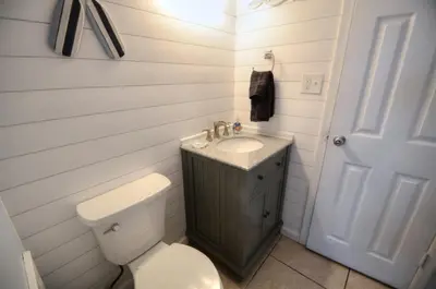 a small bathroom with a toilet and a sink at Blue Haven Villa in Panama City Beach