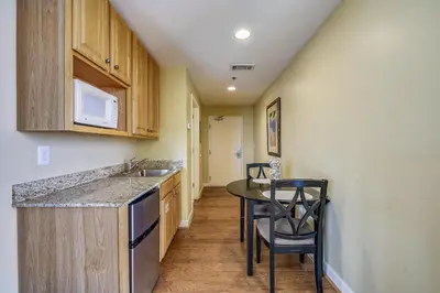a kitchen with a counter and a table and chairs at Splash Beach Resort #1601-W by Book That Condo in Panama City Beach