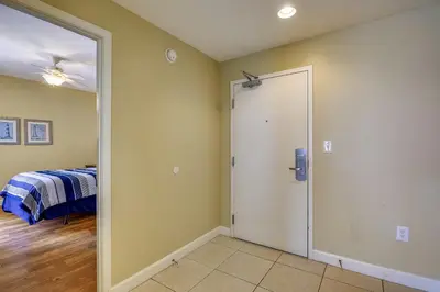 a room with a door leading to a bedroom at Splash Beach Resort #1601-W by Book That Condo in Panama City Beach