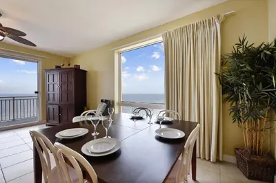 a dining room with a table and a large window at Splash Beach Resort #1601-W by Book That Condo in Panama City Beach